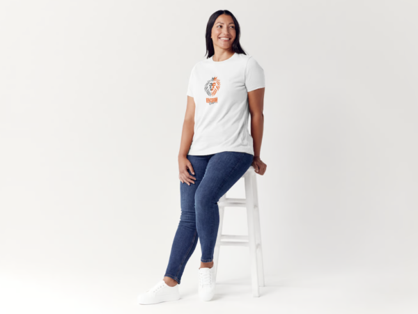 A woman sitting on top of a white stool.